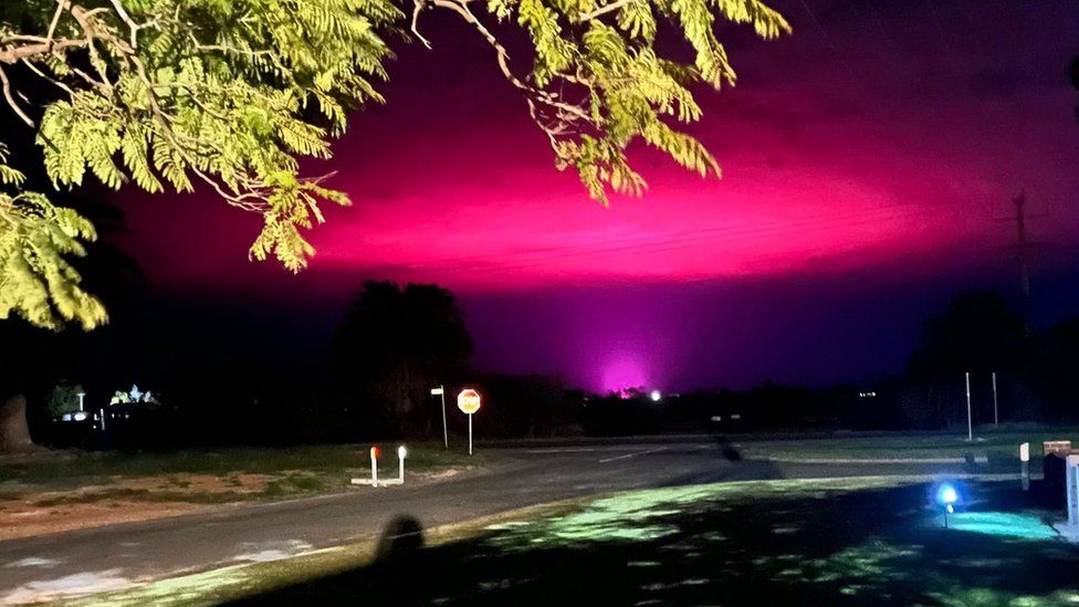 'Not aliens...': Cannabis farm behind eerie pink sky over Australian town